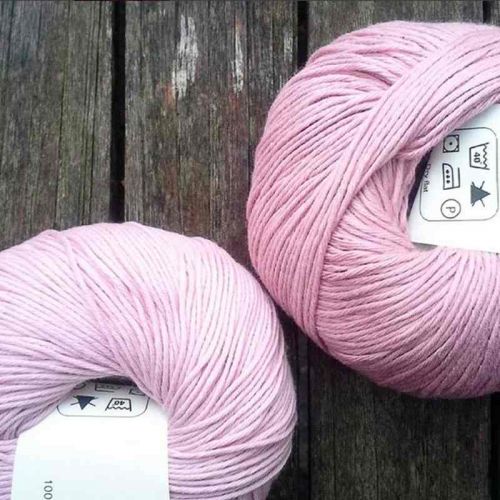 Rosa und Magnolie - Zwei Knäuel Bio-Baumwolle auf Holztisch